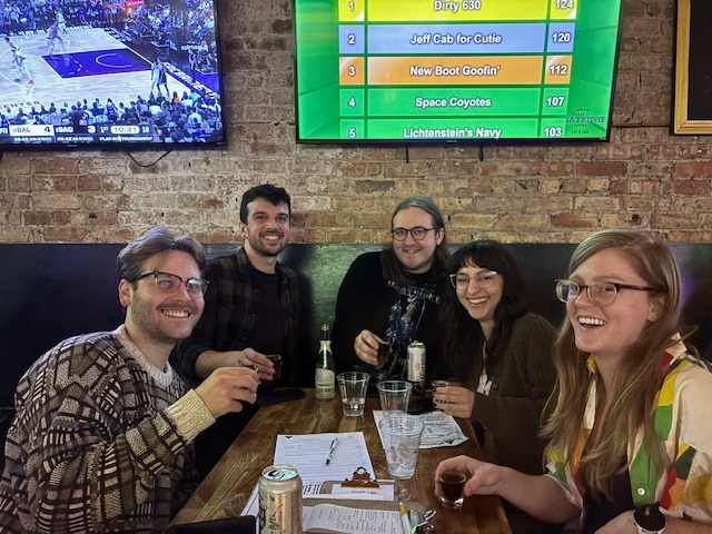 five people with shots at a bar