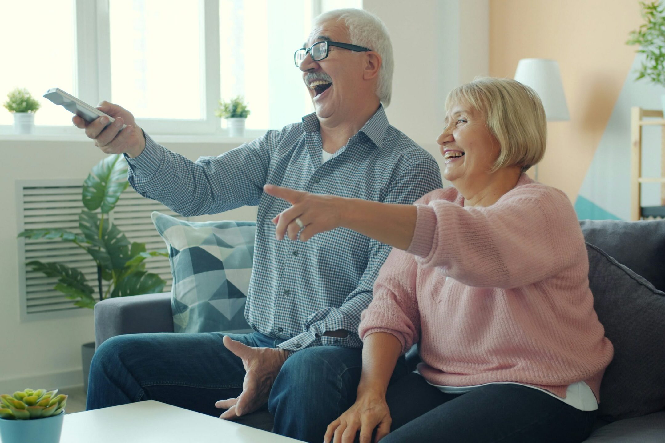 couple playing virtual trivia and laughing